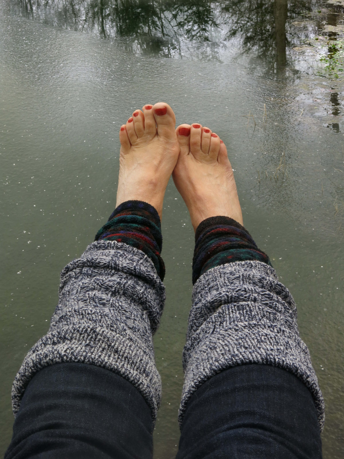 In Ithaca, New York, Robin Botie swings her red-painted toes out over the pond