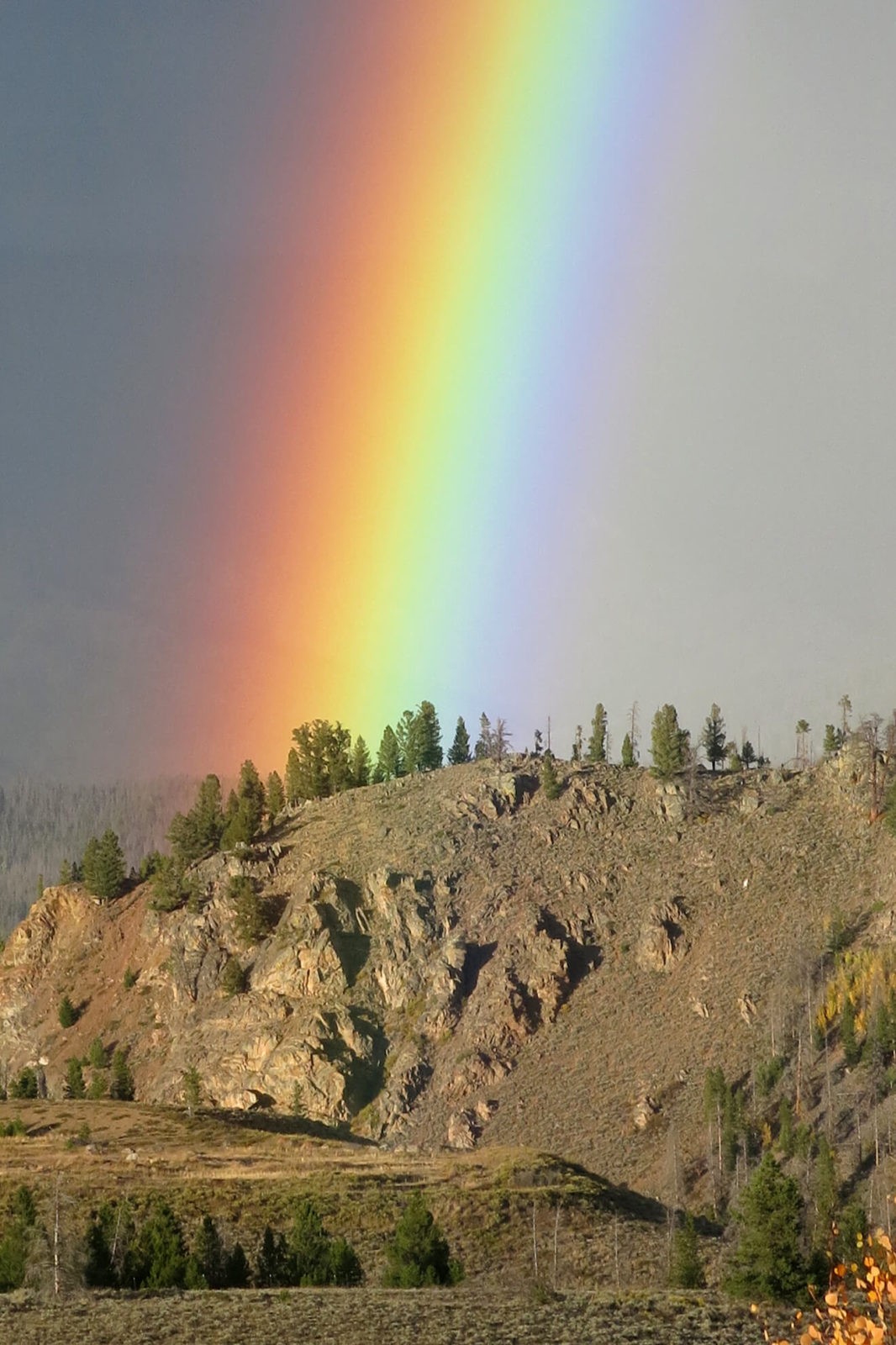 Robin Botie of ithaca, New York, photographs a rainbow at Arapaho Recreation Area