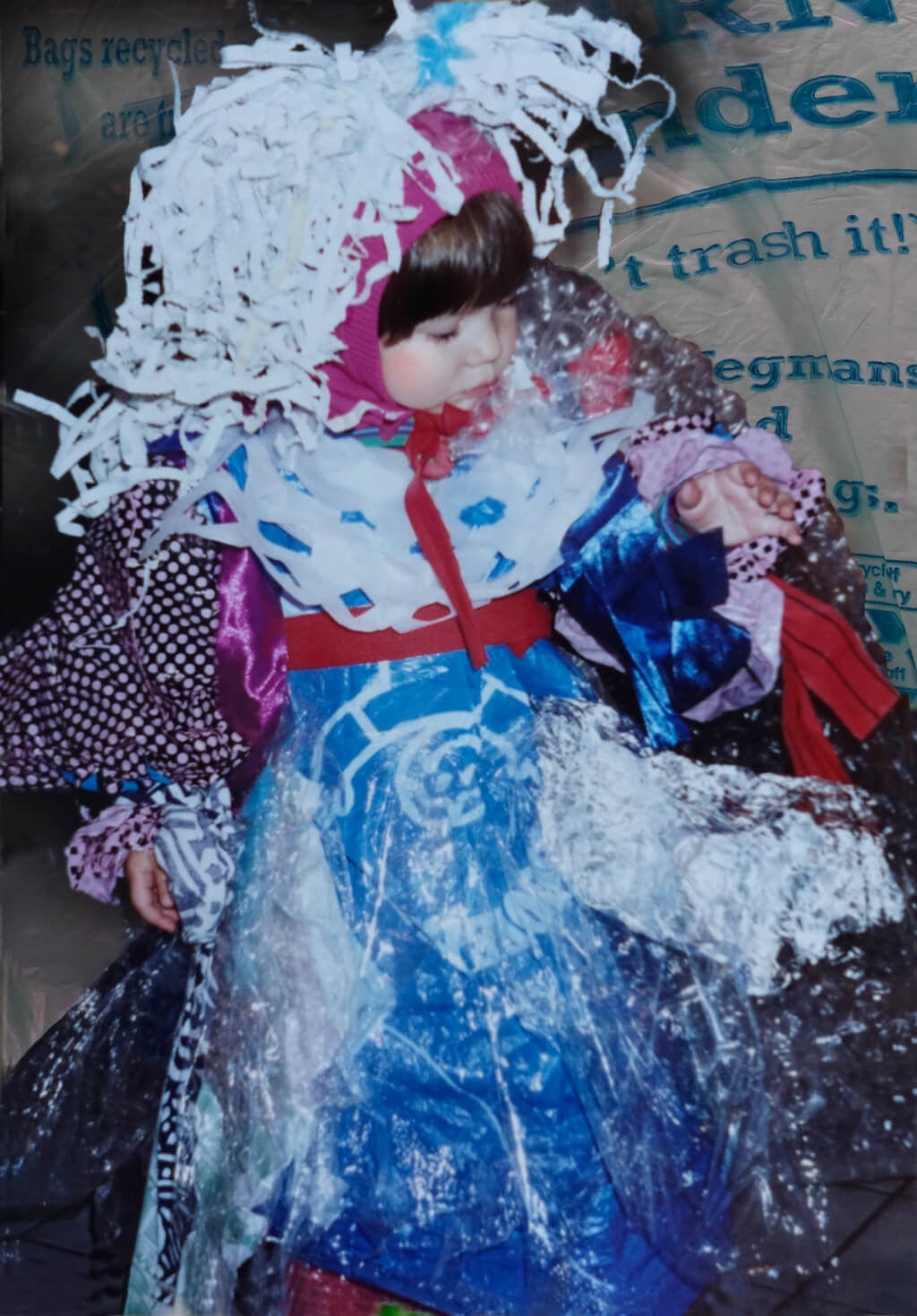 In Photoshop, Robin Botie of Ithaca, New York, restores a picture of three-year-old Marika Warden as a garbage monster, wearing a dress made of plastic bags.