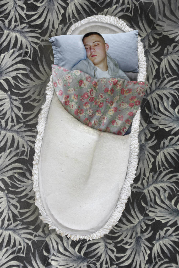 Robin Botie of Ithaca, New York, photoshops a child sleeping in a slipper-shaped bed to visualize away her back pain.