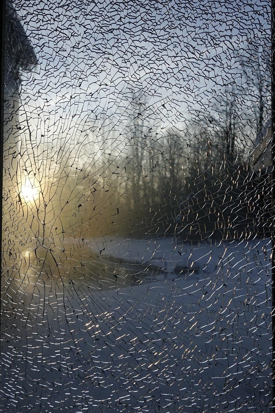 Robin Botie of Ithaca, New York, photographs ha sunrise through her shattered window. Broken but still beautiful.
